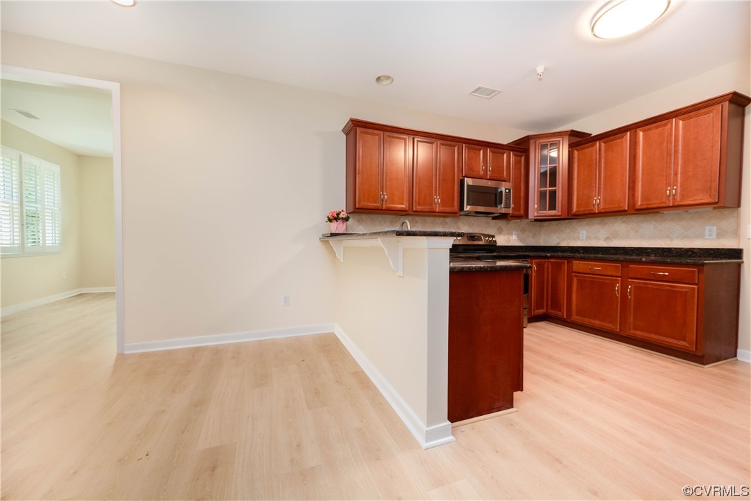 3421 Coles Point Way, Unit E Glen Allen, VA 23060 - Photo 10 of 28 a kitchen with stainless steel appliances granite countertop wooden cabinets a sink and a stove
