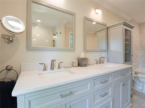 a bathroom with a granite countertop sink mirror and double