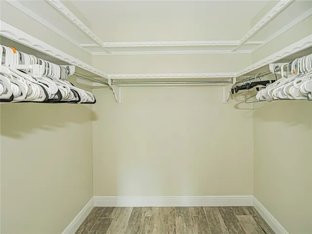 a view of walk in closet with empty racks