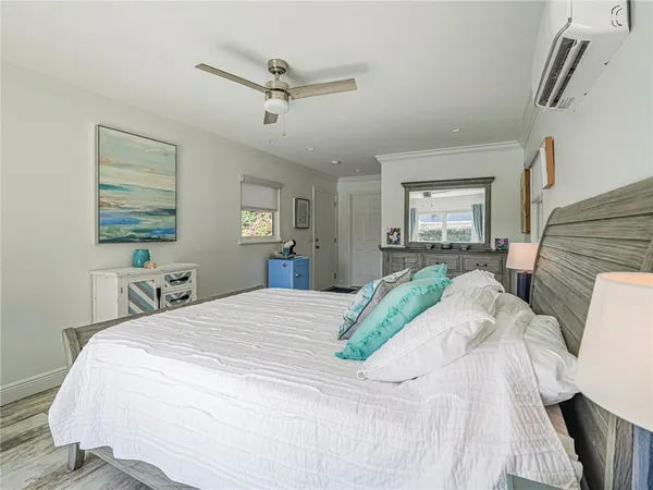 a bedroom with a bed and ceiling fan