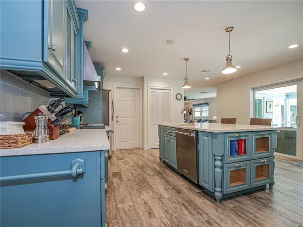 a kitchen with kitchen island a stove and a wooden floors