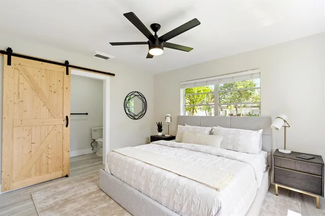 a bedroom with a large bed and a window