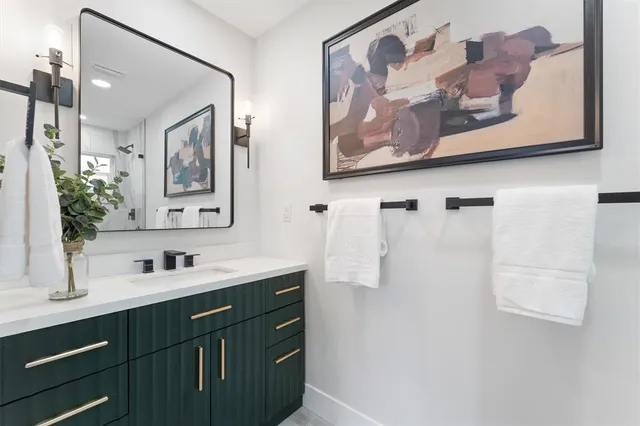 a bathroom with a sink mirror and a shower