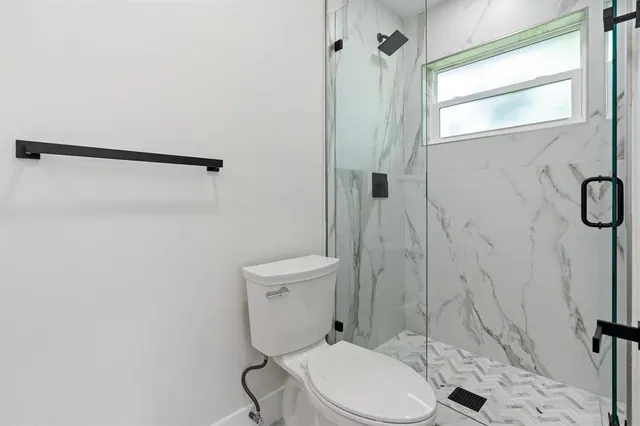 a white toilet sitting next to a bathroom sink