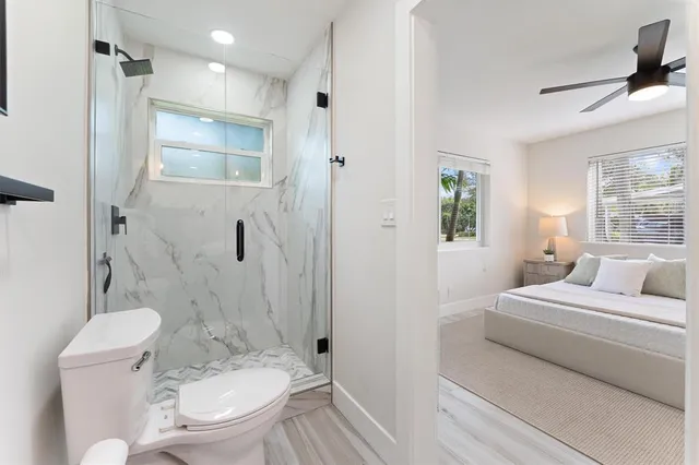 a bathroom with a toilet sink and shower