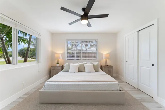 a bedroom with a large bed and a large window