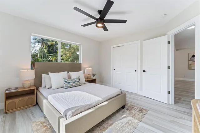 a bedroom with a bed and a ceiling fan