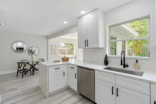 a kitchen with a sink cabinets and window
