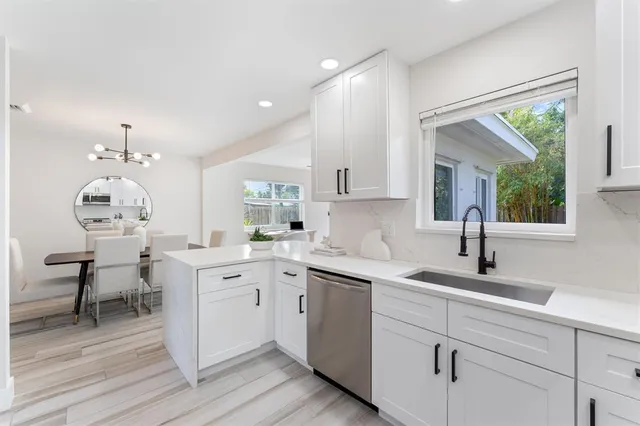 a kitchen with a sink cabinets and wooden floor