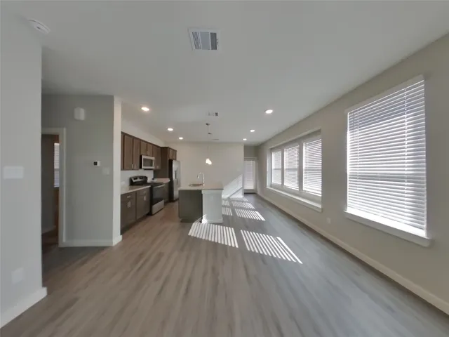 a view of a kitchen with a sink and wooden floor