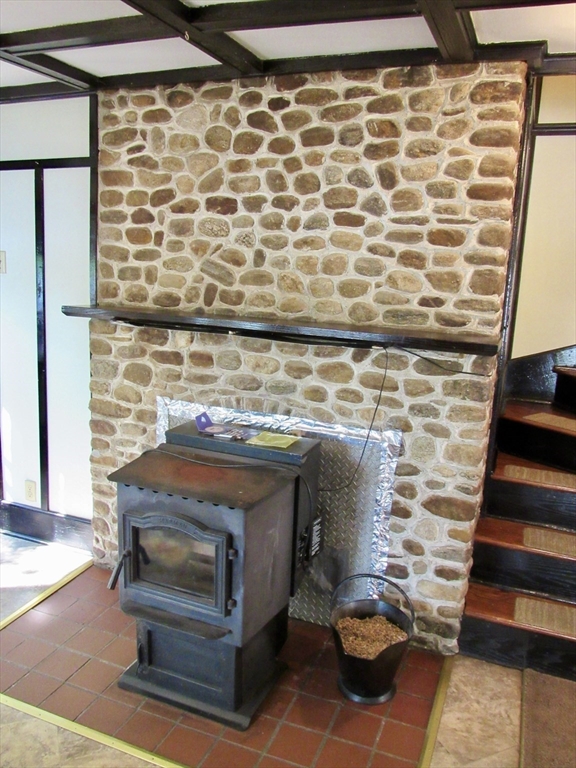 8 Union Road Wales, MA 01081 - Photo 10 of 37 a living room with a wooden floor and a fireplace