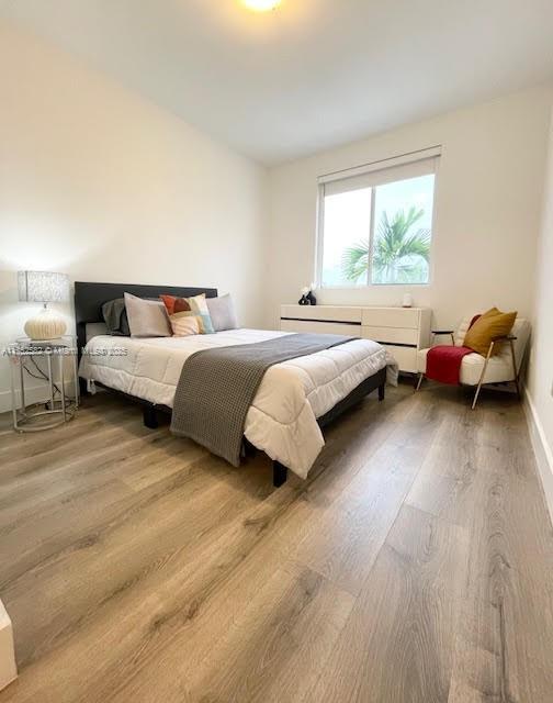 Doral Doral, FL 33178 - Photo 26 of 38 a spacious bedroom with a bed and wooden floor