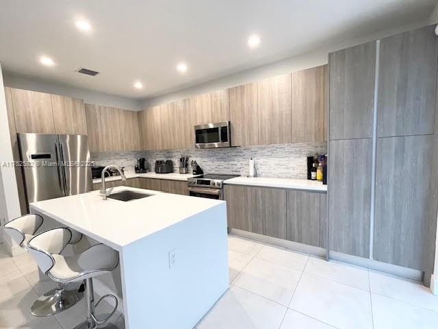 Doral Doral, FL 33178 - Photo 8 of 38 a kitchen with a refrigerator a sink and cabinets
