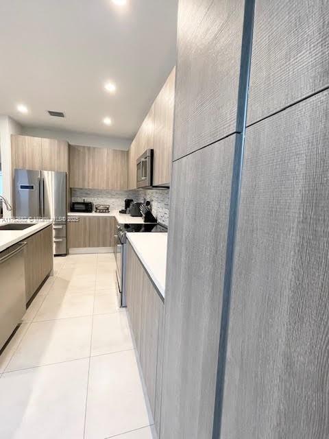 Doral Doral, FL 33178 - Photo 9 of 38 a kitchen with stainless steel appliances granite countertop a refrigerator and a sink