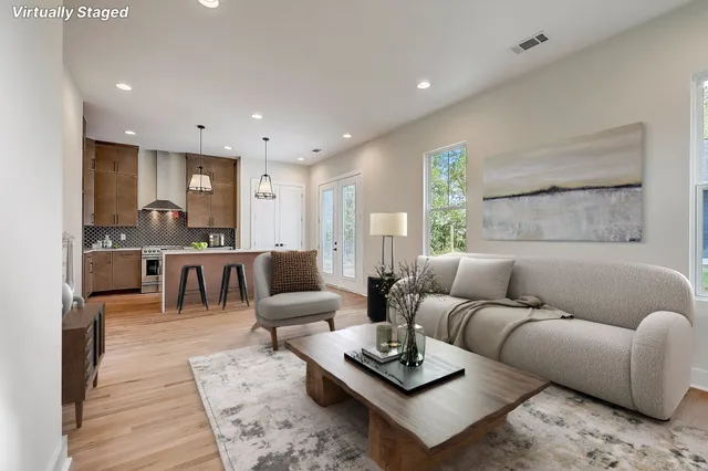 a living room with furniture and wooden floor