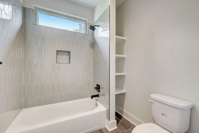 a bathroom with a toilet and a bathtub