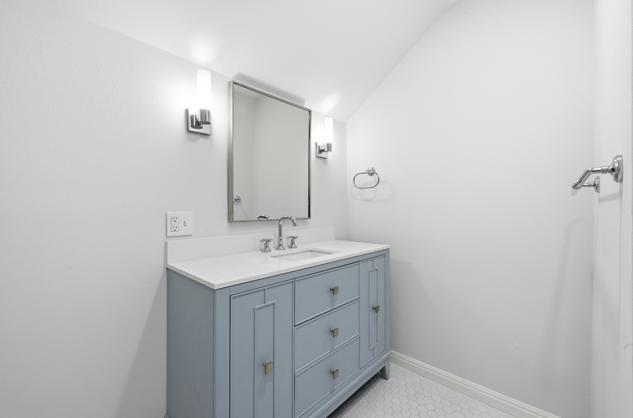 1107 Bowie Road Austin, TX 78733 - Photo 26 of 40 Elegant powder room featuring a sleek vanity and modern hexagonal tile flooring.