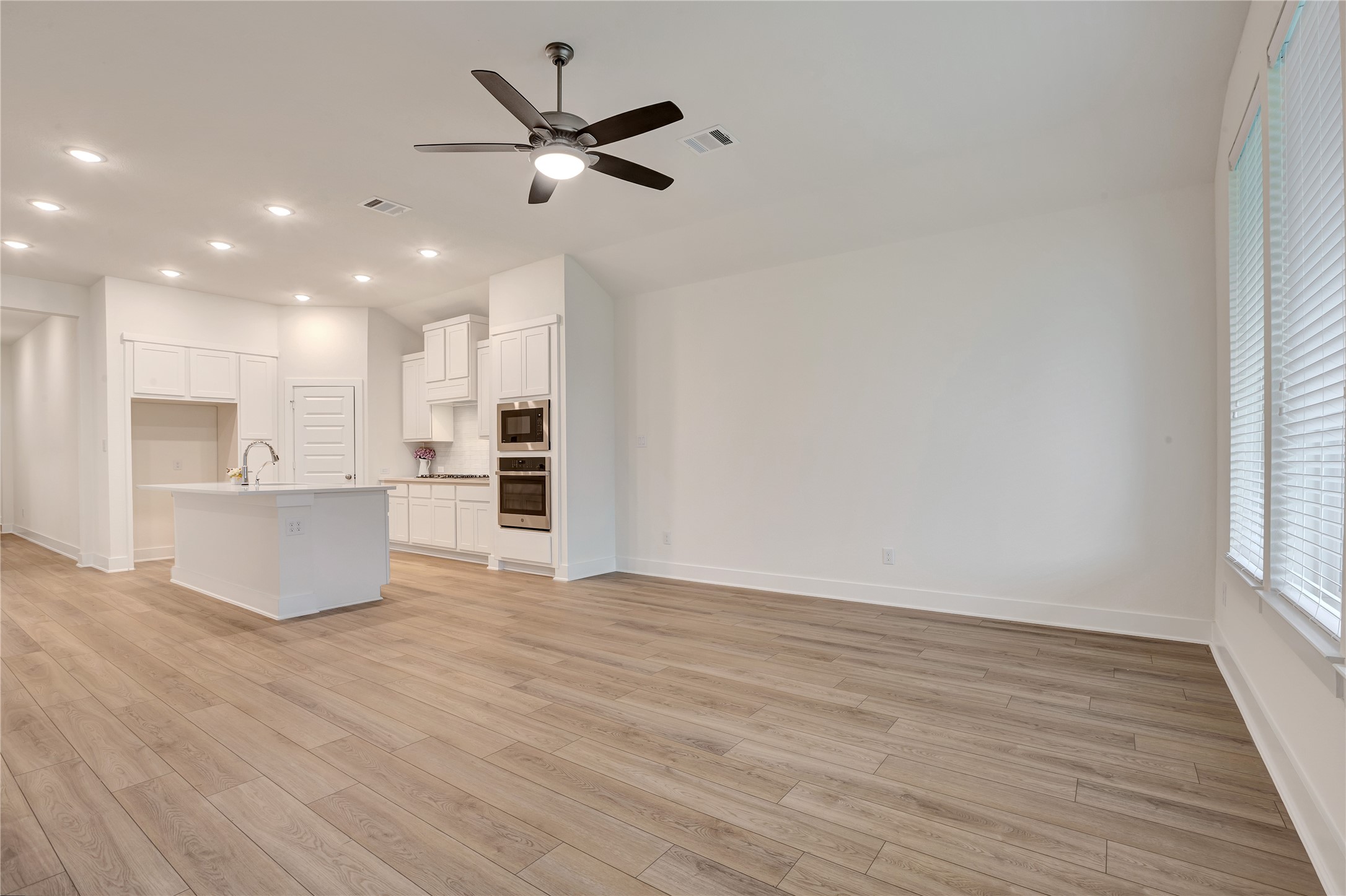 6027 Churchill Spgs Lane Fulshear, TX 77441 - Photo 13 of 25 a view of a kitchen with a sink and a window
