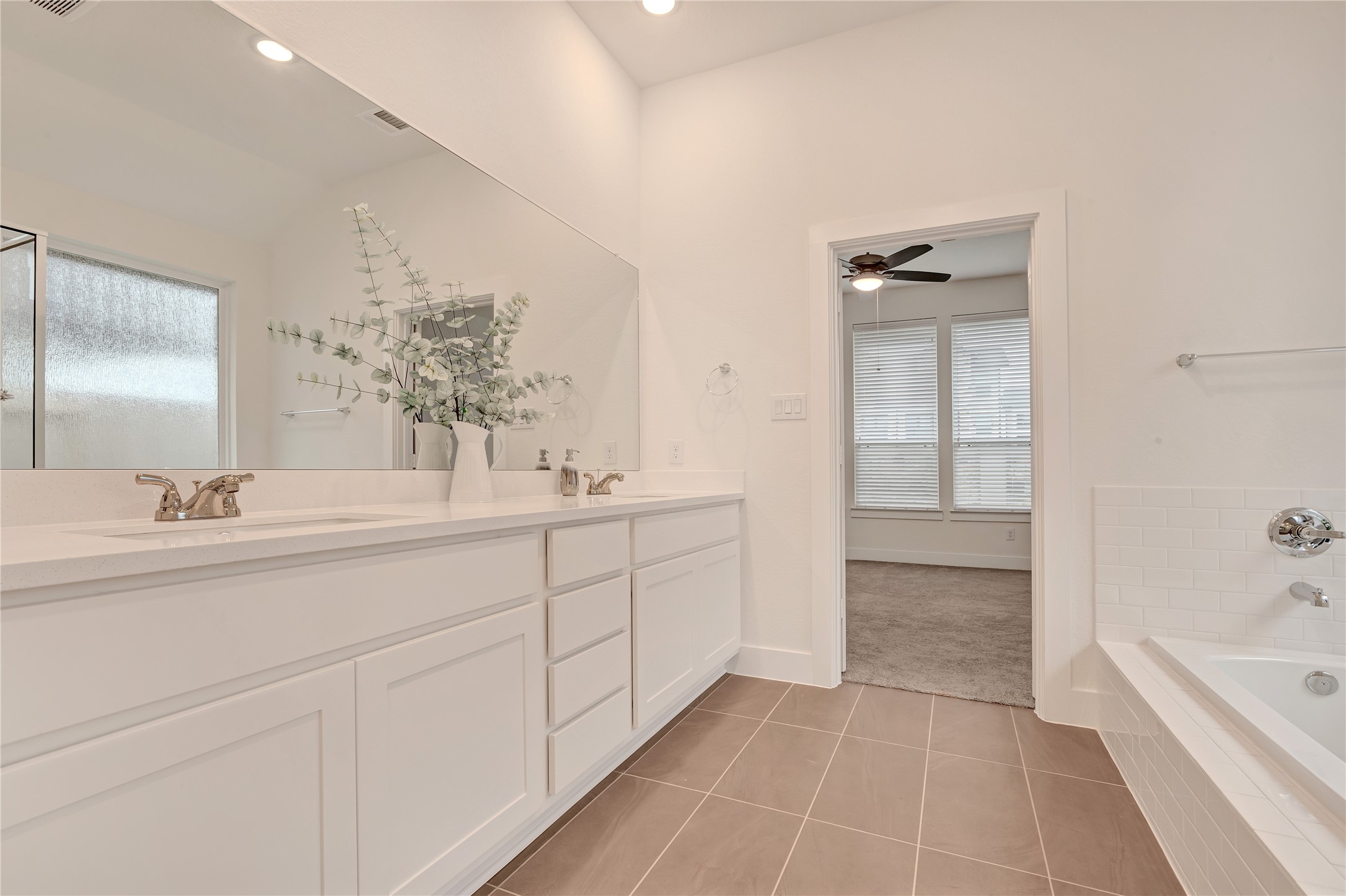 6027 Churchill Spgs Lane Fulshear, TX 77441 - Photo 18 of 25 a spacious bathroom with a tub sink and mirror