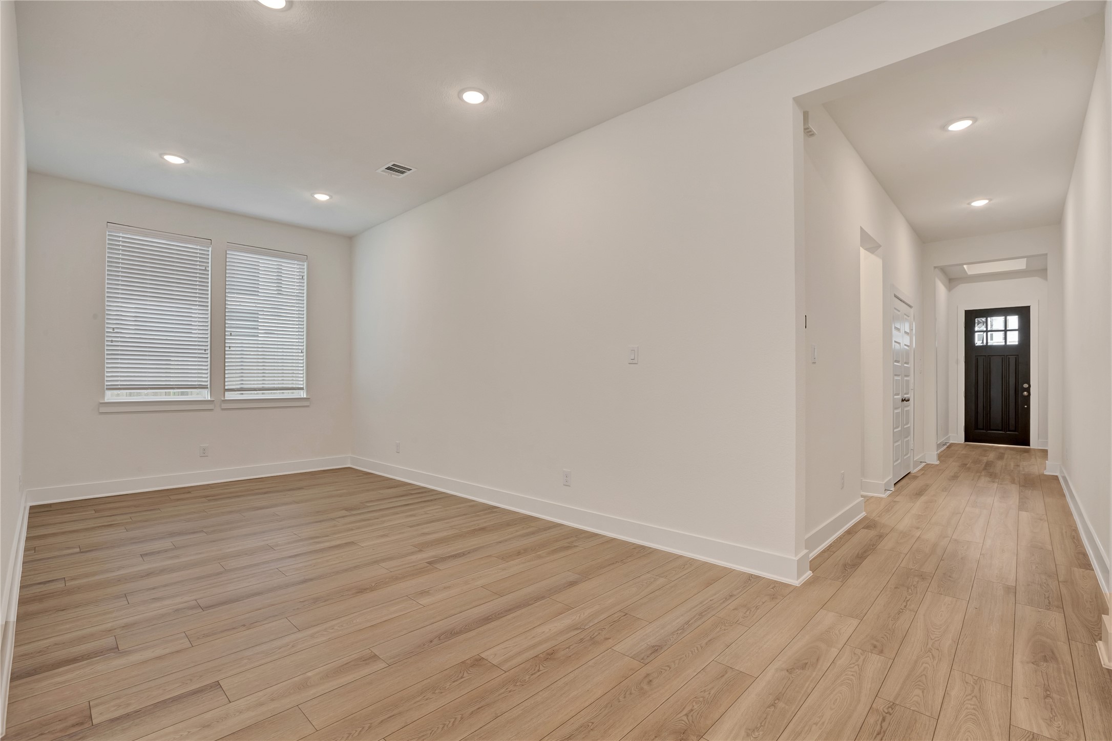6027 Churchill Spgs Lane Fulshear, TX 77441 - Photo 3 of 25 wooden floor in an empty room with a window