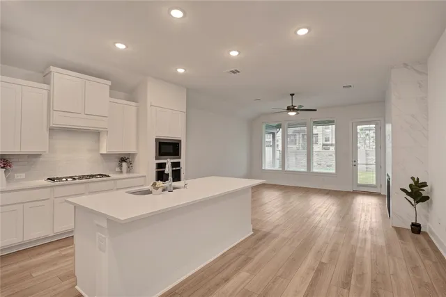 a kitchen with a stove a sink and a refrigerator