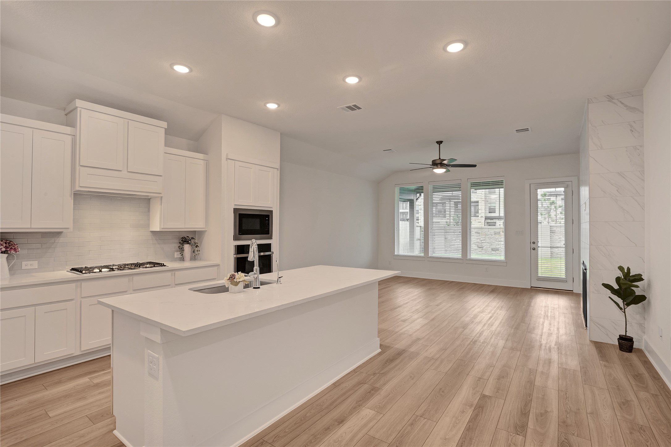 6027 Churchill Spgs Lane Fulshear, TX 77441 - Photo 8 of 25 a kitchen with a stove a sink and a refrigerator