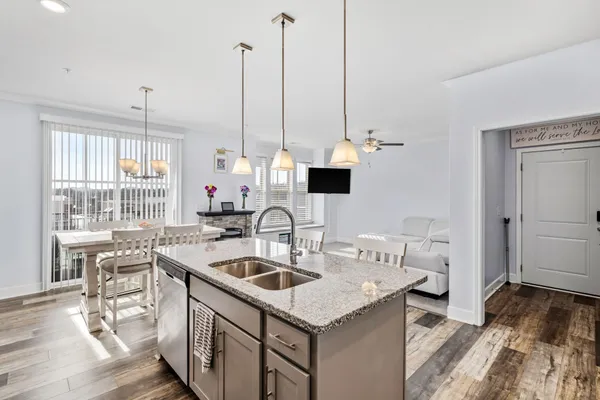 a kitchen with a sink a stove and chairs