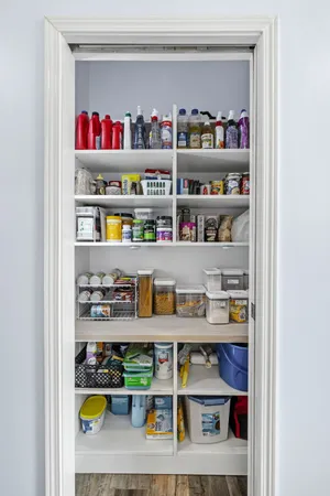 a cabinet with granite countertop lots of different kinds of food