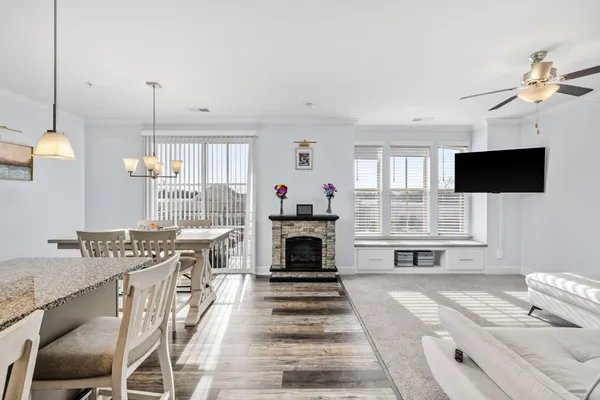 a living room with furniture a fireplace and a flat screen tv