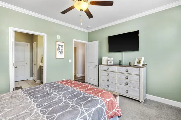 a bedroom with a bed and a flat screen tv in a dresser