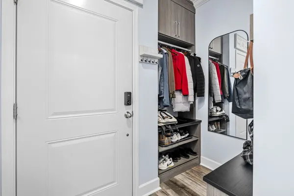 a view of walk in closet with clothes and shoes
