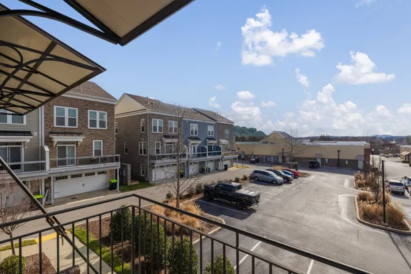 a view of a balcony with cars parked