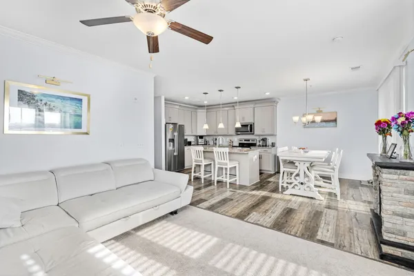 a living room with furniture and kitchen view