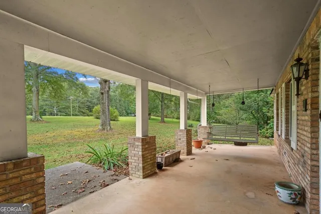 a view of a room with floor to ceiling windows and garden