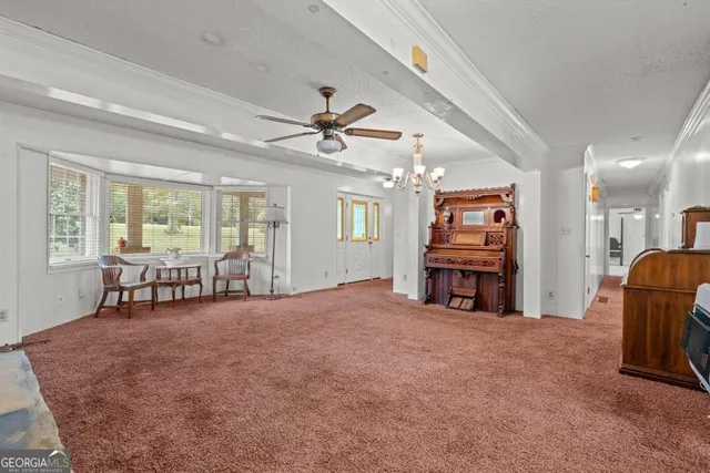 a view of a livingroom with furniture and a ceiling fan