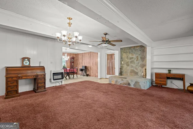 a view of an empty room with a fireplace and a window