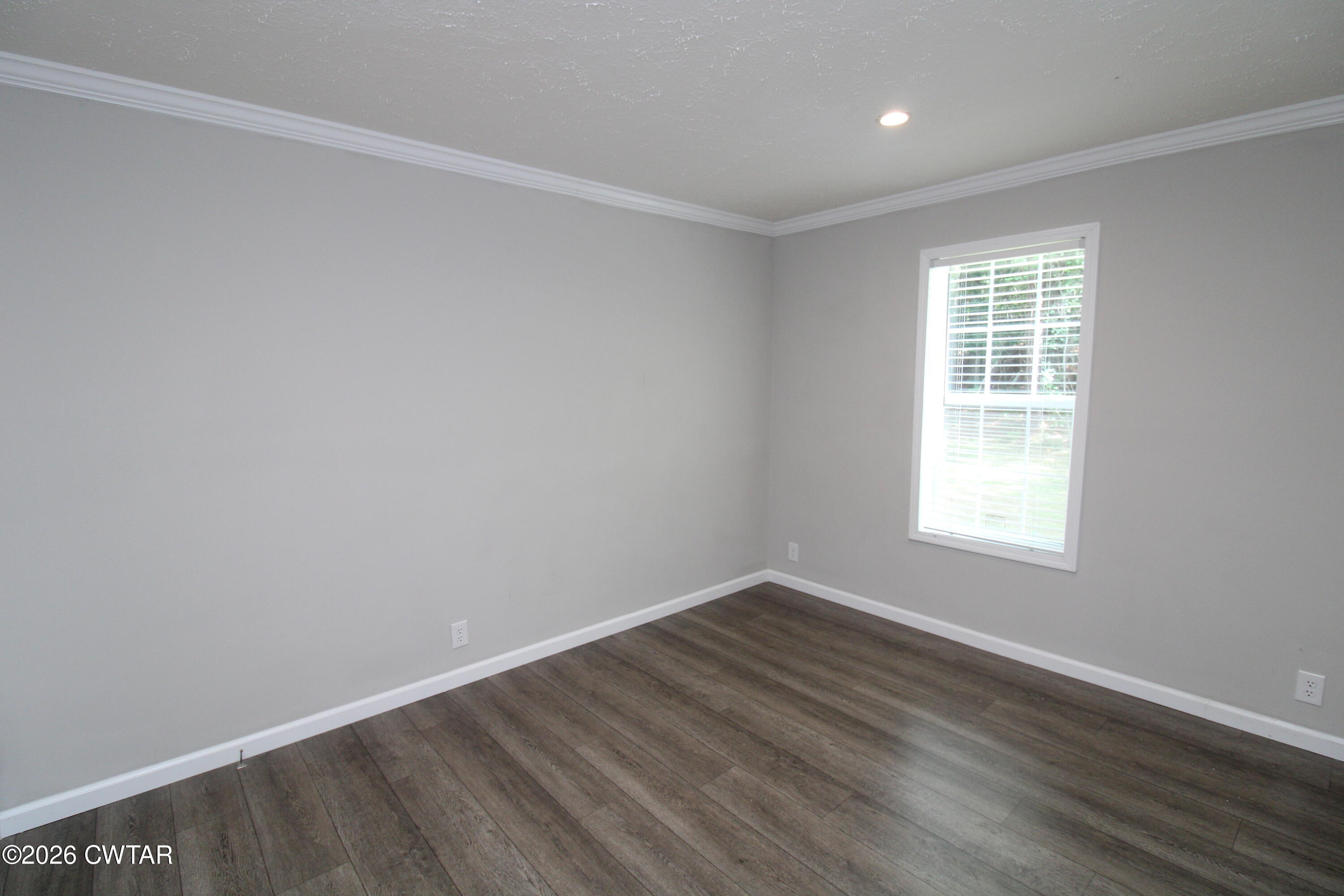 398 Pope Road Lexington, TN 38351 - Photo 15 of 21 wooden floor in an empty room with a window