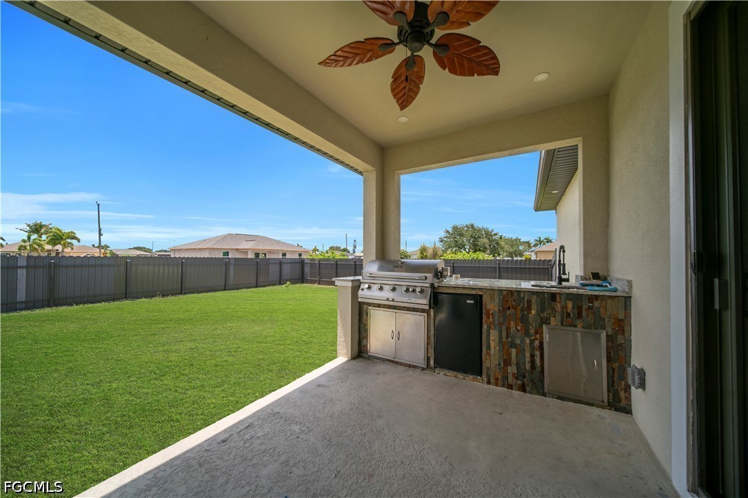 1128 Nelson Road North Cape Coral, FL 33993 - Photo 21 of 22 a view of a kitchen with a sink and a yard