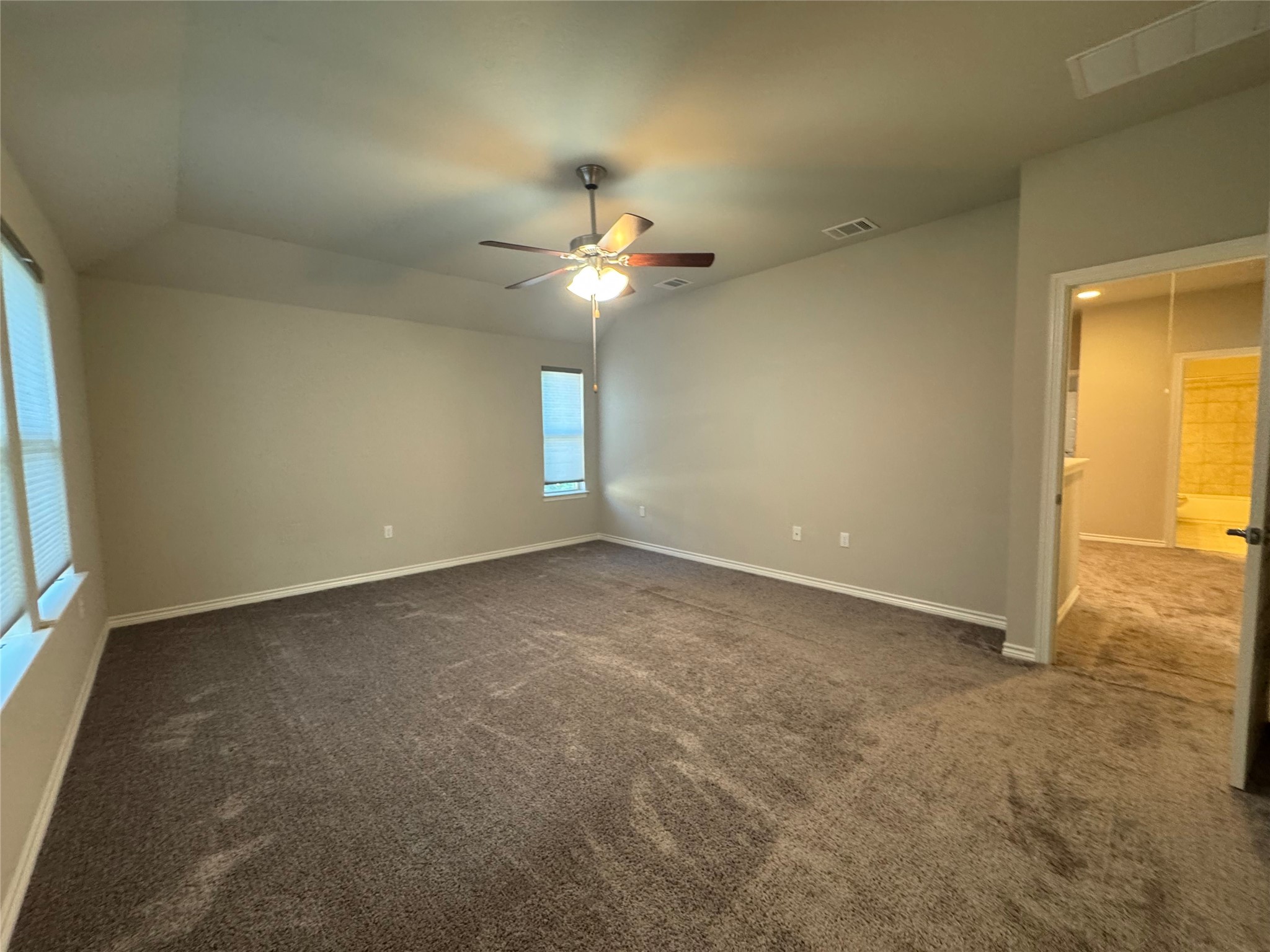 14100 McCoy Loop, Unit 1 Austin, TX 78717 - Photo 16 of 39 An airy bedroom awaits with soft carpeting and a welcoming ceiling fan.