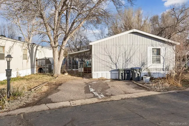 a view of a house with a yard covered in snow