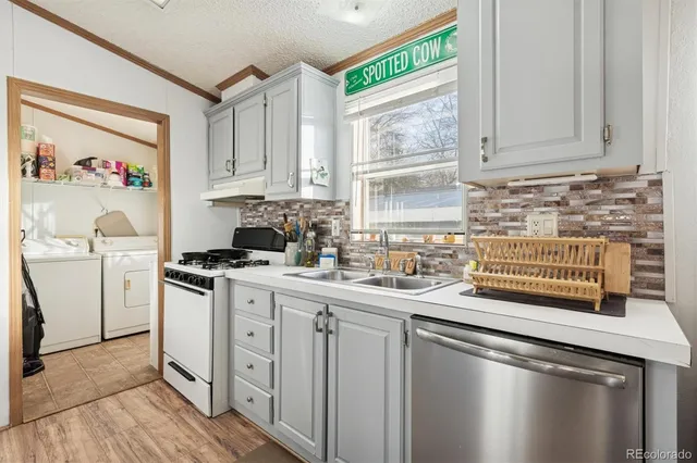 a kitchen with a sink stove and cabinets
