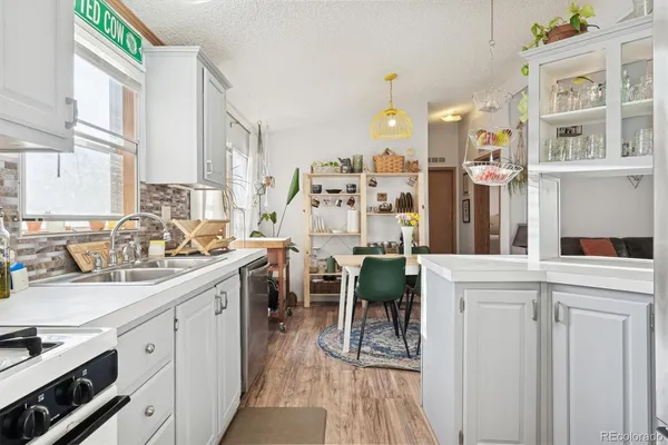 a kitchen with cabinets and chairs