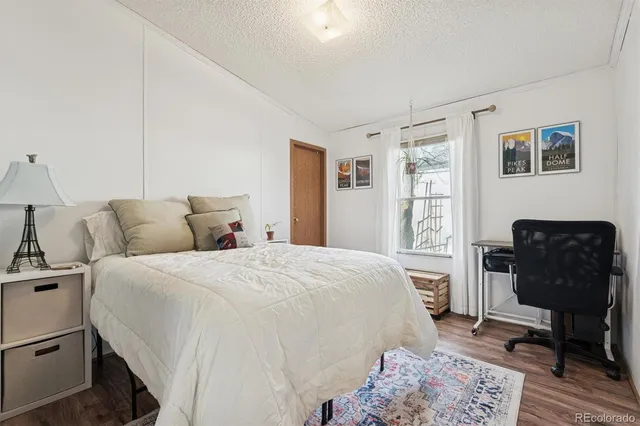 a bedroom with a bed and chair