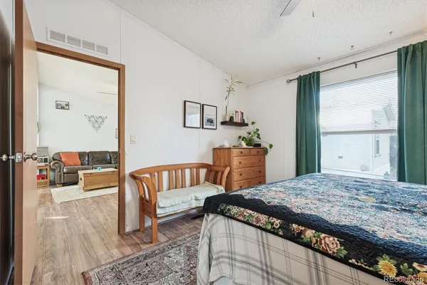 a bedroom with a bed and a dresser in it