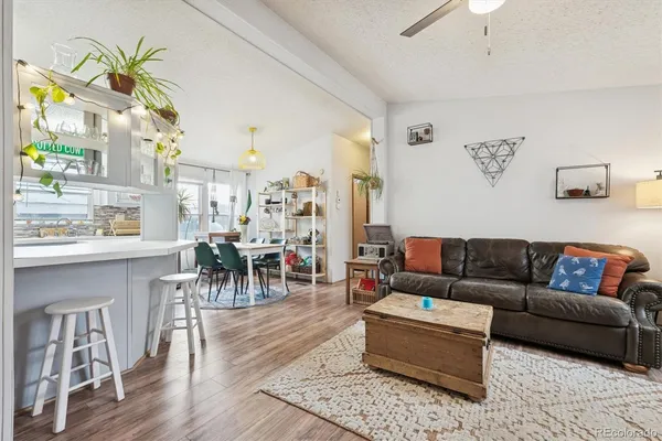 a living room with furniture and wooden floor