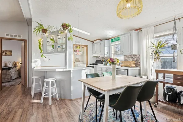 a kitchen with a table chairs and a refrigerator
