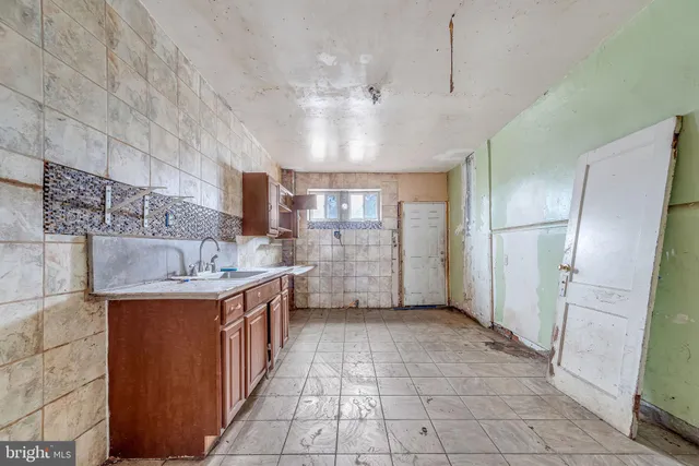 a large kitchen with stainless steel appliances granite countertop a sink and refrigerator