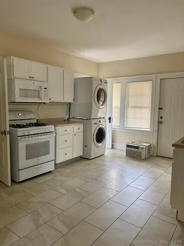 a kitchen with a stove a sink and a microwave