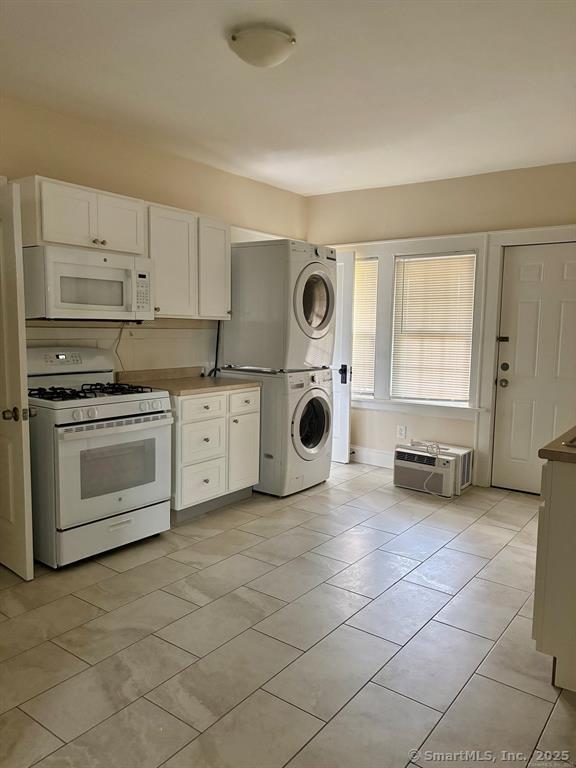 138 Mill Hill Avenue, Unit 1 Bridgeport, CT 06610 - Photo 2 of 8 a kitchen with a stove a sink and a microwave