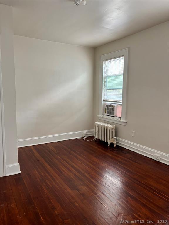 138 Mill Hill Avenue, Unit 1 Bridgeport, CT 06610 - Photo 6 of 8 an empty room with wooden floor and windows